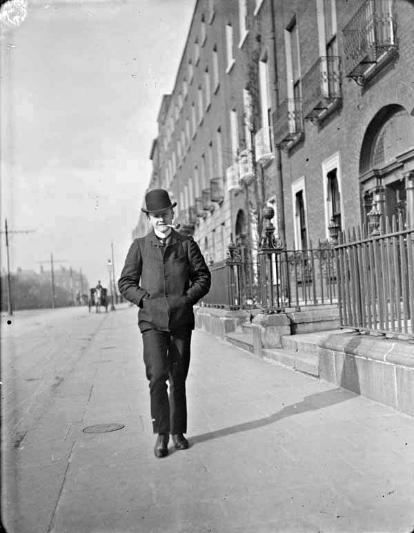 Young man walking and smoking pipe on Merrion Square