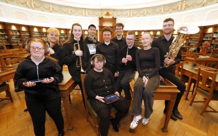 Group of musicians posing in the NLI's reading room