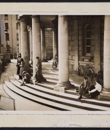 Men and women sitting on the steps of the NLI.