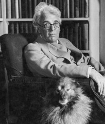 Yeats sitting in armchair with his dog