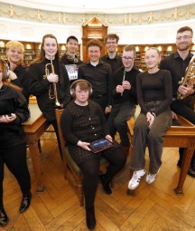 Group of musicians posing in the NLI's reading room