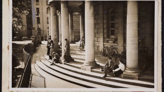 Men and women sitting on the steps of the NLI.