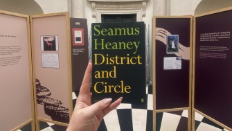 a copy of seamus heaney's poetry collection 'district and circle' in the exhibition entrance 