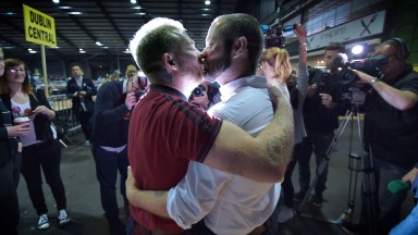 Michael Barron and Jaime Nanci kiss during the Marriage Equality Count 