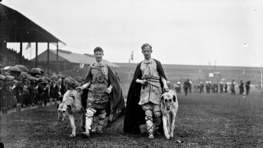 Two men with wolfhounds at Tailteann Opening Parade. 