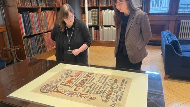 Staff with large poster