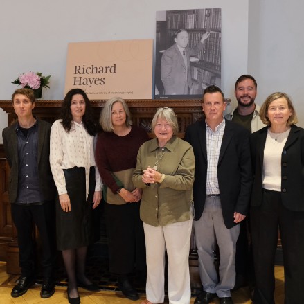 Group photo with men and women in the Richard Hayes Room