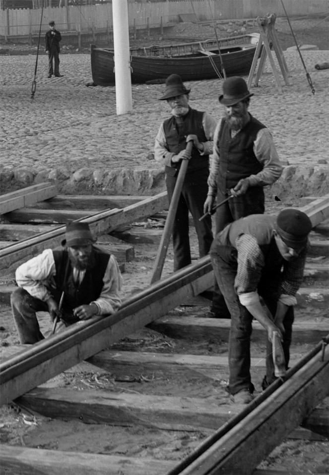 Detail from one of our Lawrence Royal photographs - Men working at Belfast Docks laying a baulk road for the internal dock railway, circa 1890. NLI ref. LROY 02383