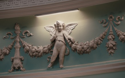 A moulded cherub in the detail of the NLI Main Reading Room decorations