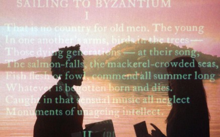 Image of students behind screen of text inside the Yeats exhibition at the NLI