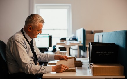 Image of staff member cataloguing the collections