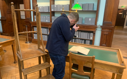 Image of photographer taking photo of book in Reading Room