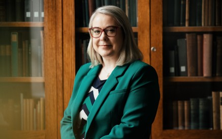 Image of Director in office with bookshelf in background