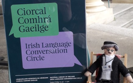 Joyce finger puppet sitting on steps outside the nLI