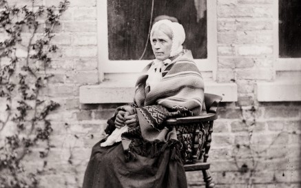 Portrait of servant woman, known as widow kelly, seated outside the photograph house, Clonbrock, Co.Galway